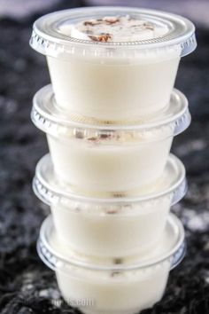 three plastic containers stacked on top of each other with food in the middle and one container filled with liquid