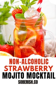 a mason jar filled with fruit and ice on top of a table next to strawberries