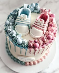 there is a cake decorated with baby shoes