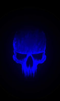 a blue skull with glowing eyes in the dark