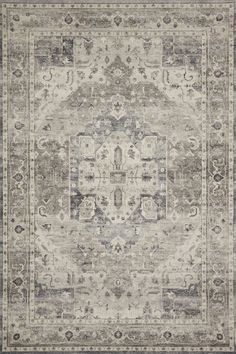 an antique style rug in grey and beige tones