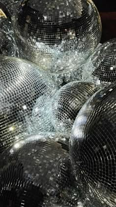 many disco balls are broken and sitting on the ground