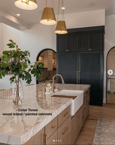 a large kitchen with marble counter tops and wooden cabinetry, along with hanging lights