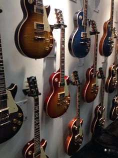 guitars are lined up on the wall