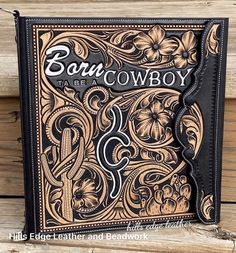 a book that is sitting on top of a wooden table, with the title'born to be a cowboy '