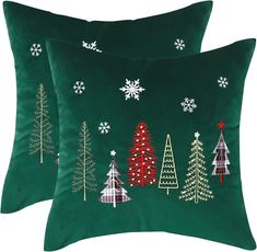 two green christmas pillows with trees on them