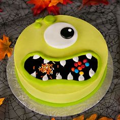 a green monster cake with sprinkles and eyes