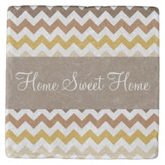 a stone coaster with the words home sweet home written on it in white and brown