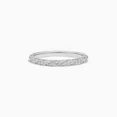 a white gold wedding band with diamonds on the sides and a twist design in the middle