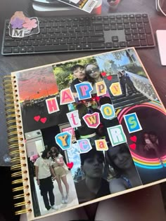 an open notebook with the words happy new year written on it and photos cut out