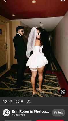 a man and woman in wedding attire walking down a hall way with the caption's name on it