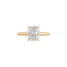 a gold ring with a cushion cut diamond