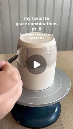 someone is painting the top of a cup