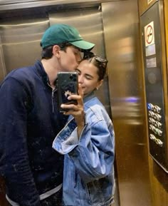 a man and woman kissing in an elevator