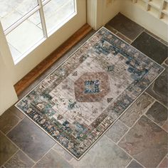 an area rug is on the floor in front of a door and windows with glass panes