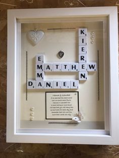 scrabbles are arranged in a shadow box to spell out the word love