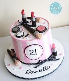 a birthday cake with makeup and lipstick on it that says 21 daisie's