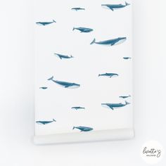 a white wall with blue whales on it