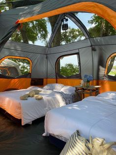 there are two beds in the inside of a tent