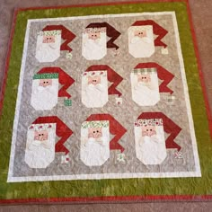 a quilted christmas scene with santas and snowmen