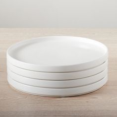 four white plates stacked on top of each other