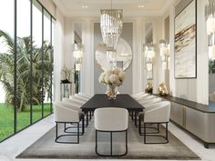 an elegant dining room with white chairs and chandelier