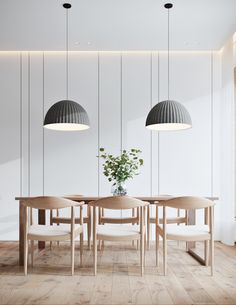 a dining room table with four chairs and a potted plant