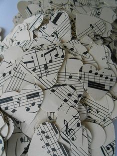 many pieces of paper with musical notes on them are arranged in the shape of hearts