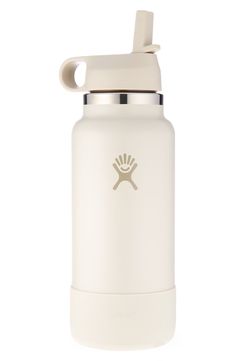 the hydro bottle is white and has a gold emblem on the side, while it's attached to a metal lid