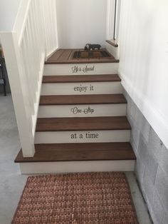 the stairs are painted with words on them, and there is also a rug underneath