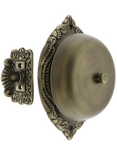 an antique style door handle with ornate design on the front and back side of it