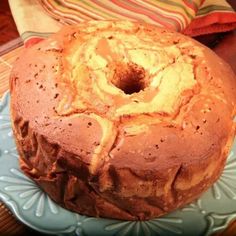 a bundt cake sitting on top of a blue plate next to a red and white napkin