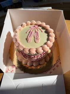 a cake in a box with pink icing