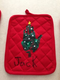 a red pot holder with a christmas tree on it and the words deck written in black