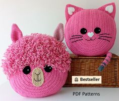 two crocheted stuffed animals sitting next to each other on top of a basket