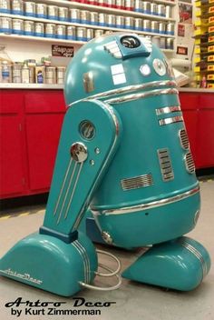 a blue robot sitting on the ground in a store