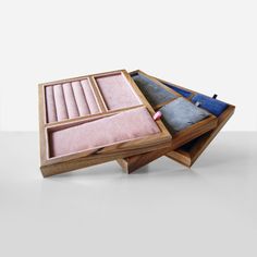 three wooden trays filled with different types of fabrics and fabric in each one's compartments