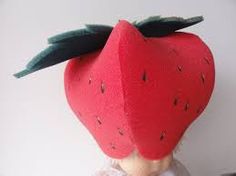 a doll with a strawberry hat on it's head