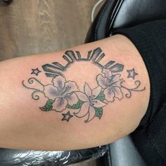 a woman's arm with flowers and stars on it, in the shape of a circle