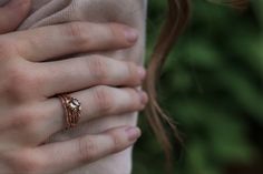 Wedding set made in rose or pink gold. Bark textured twigs swirl in several branching rows. There is a round rose cut diamond light brown in color, accented by six very small diamonds scattered in tiny cherry blossoms on the branches. The main ring is wide and the wedding band is slender and curved to fit. Rose Gold Flower Ring, Cherry Blossom Wedding, Rose Gold Engagement, Rose Gold Wedding, Diamond Set, A Rose