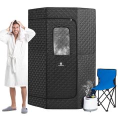 a man in a bathrobe standing next to a black portable shower and chair