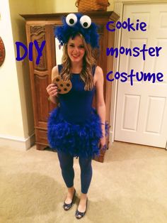 a woman in a cookie monster costume holding a cookie