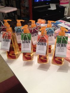 several bottles of hand sanitizers sitting on a table in front of a tv