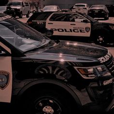 a police car is parked in front of other cars