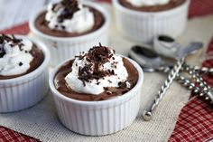 a bowl filled with ice cream covered in chocolate and nuts