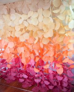 an art installation made out of orange and pink paper leaves