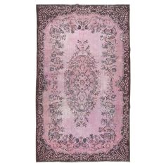 a pink rug with an ornate design on it