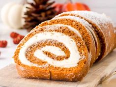 a cinnamon roll with icing sitting on top of a cutting board