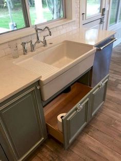 a kitchen sink with an open drawer in the middle