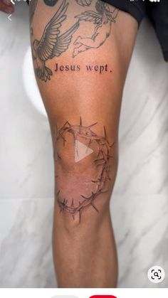 a tattoo on the leg of a person with jesus weft